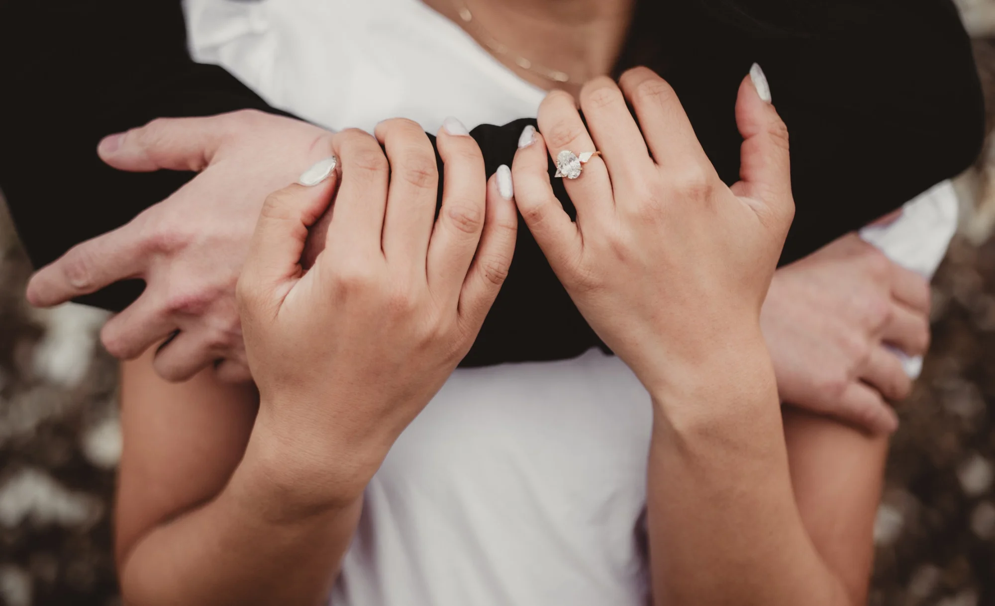 A newly engaged couple hugging