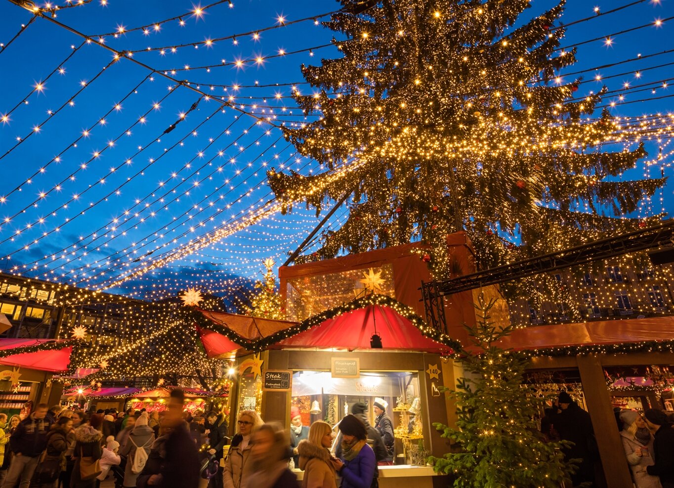 A European Christmas market stalls and string lights