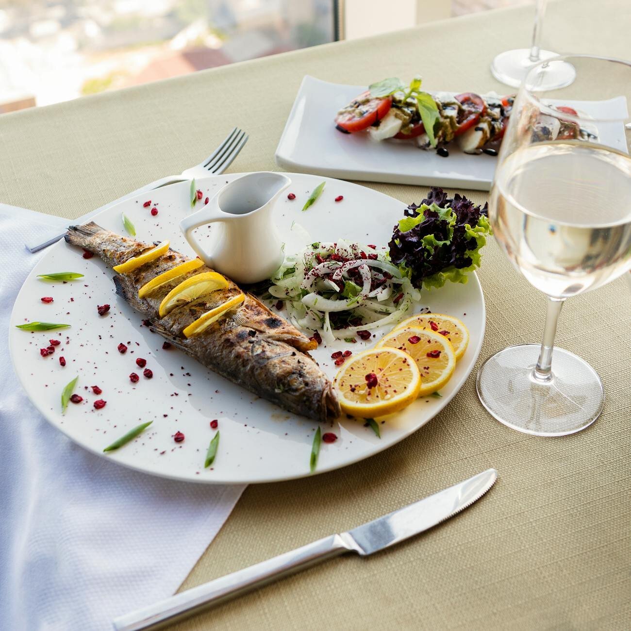 Dish with cod with saffron rice with white wine on the side