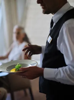 Crewmember bringing food to guest