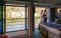 A couple on the twin balcony of an AmaSonata stateroom