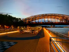 AmaSiena sun deck with floor lights on in Cologne, Germany with a bridge in the background