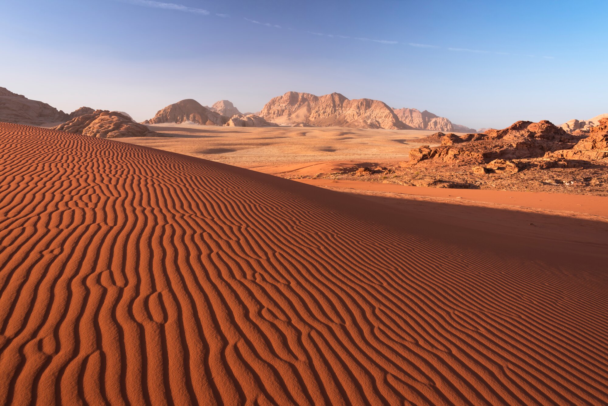 Ripple texture of sandy dune and moutaines background in Wadi Rum desert, Jordan