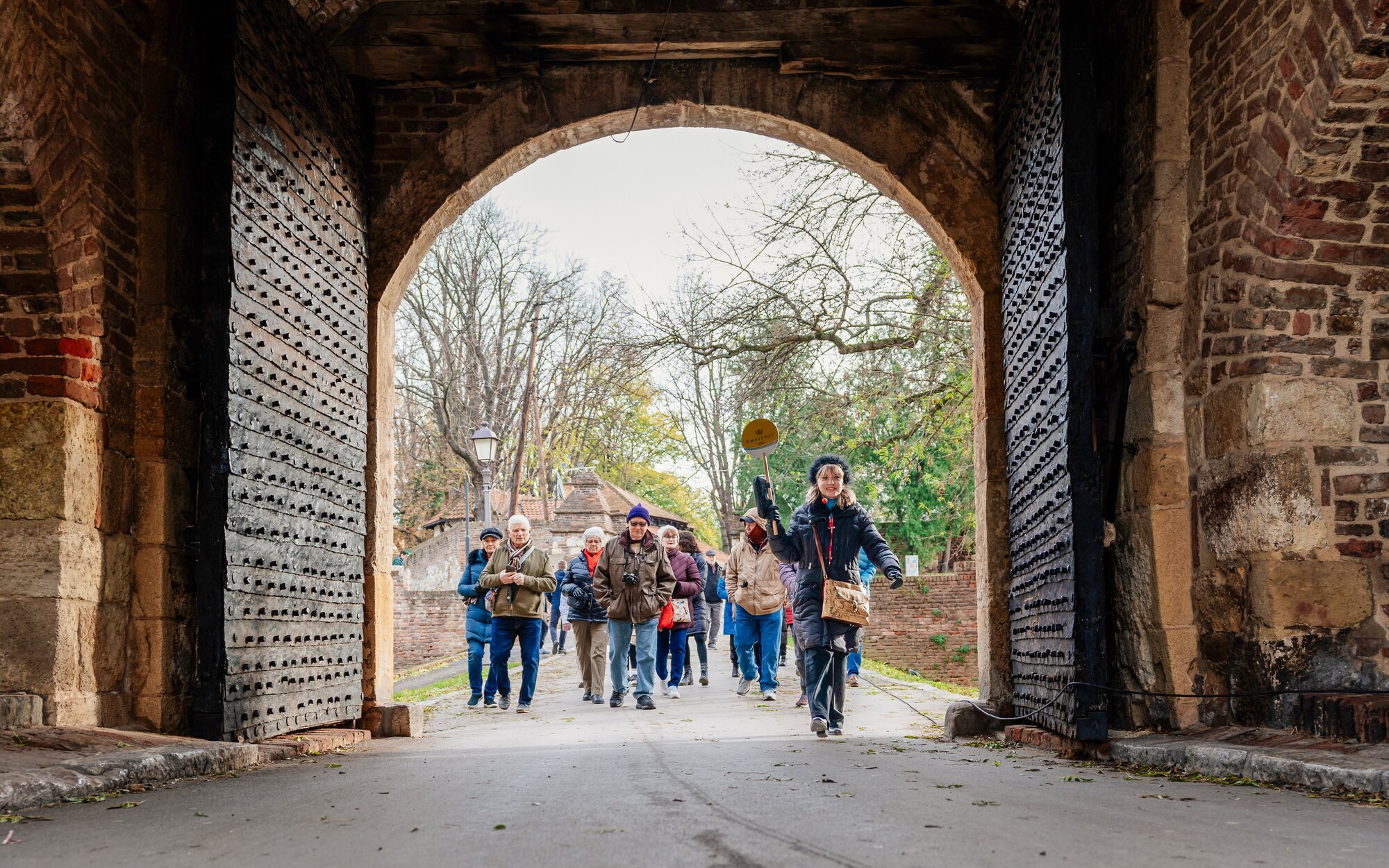 Group of people walking through the entrance of the Kalemegdan in Belgrade, Serbia