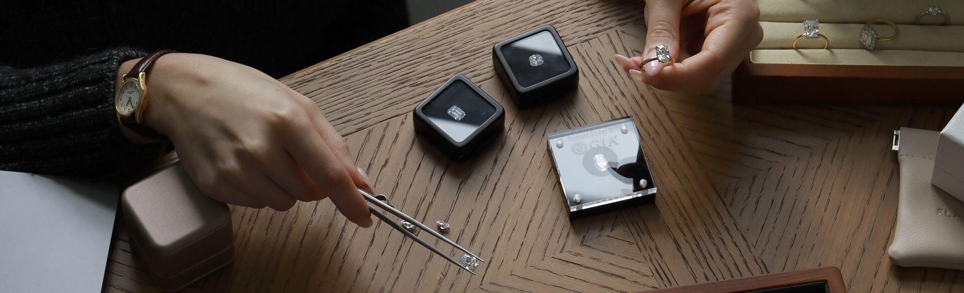 Jeweller selecting diamonds for custom engagement ring design