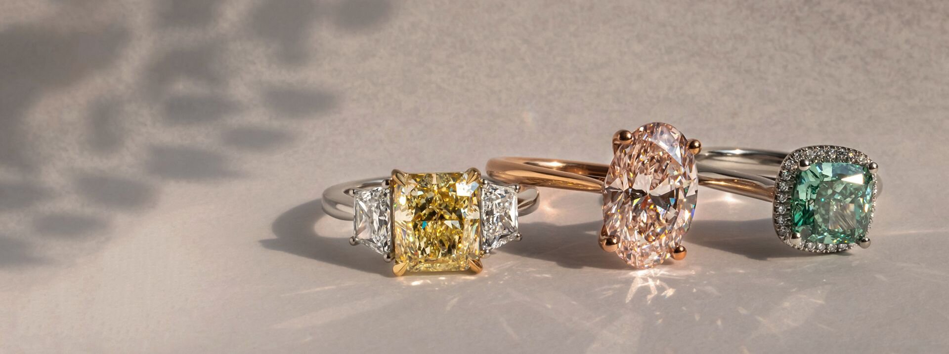 Fancy coloured diamond engagement rings in yellow, pink and green