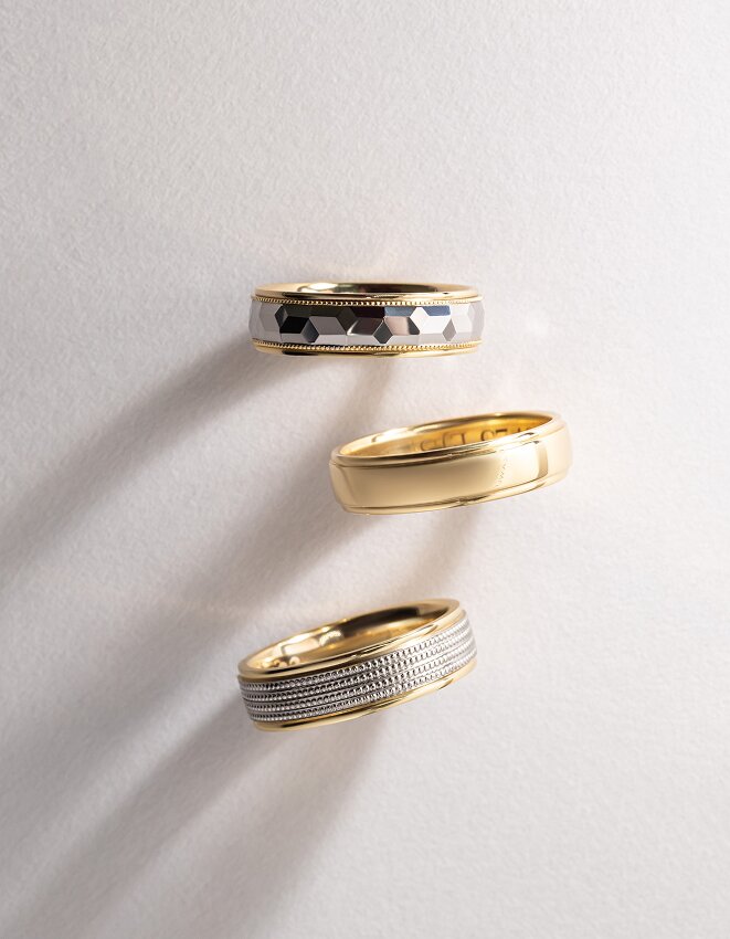 Gold men’s wedding bands with textured and polished finishes