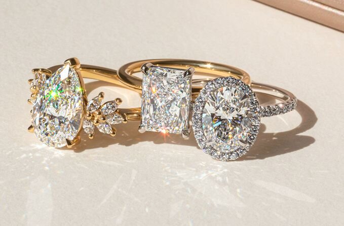 Diamond engagement rings in pear, radiant and oval cuts