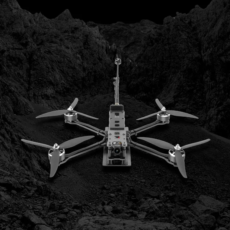 Lumenier NightHawk AttriX7 drone in a rugged landscape.
