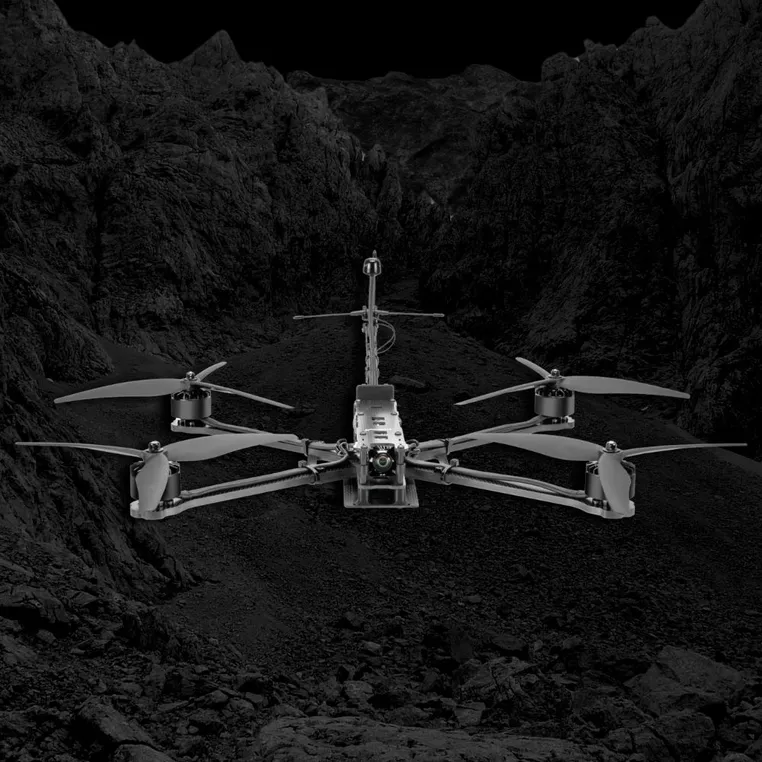 Lumenier NightHawk AttriX10 drone in a rugged landscape.