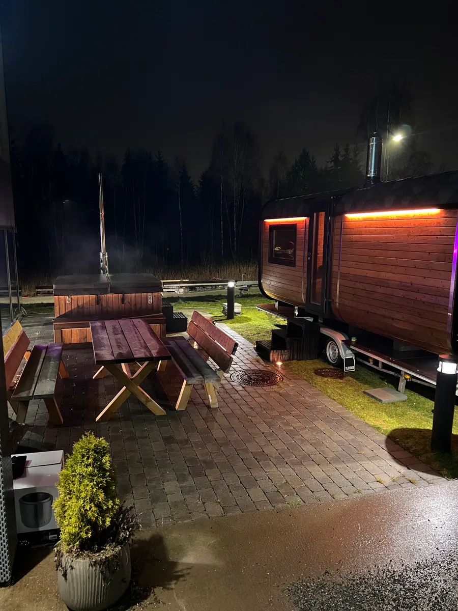 FlyTribe Oslo outdoor sauna and hot tub at night