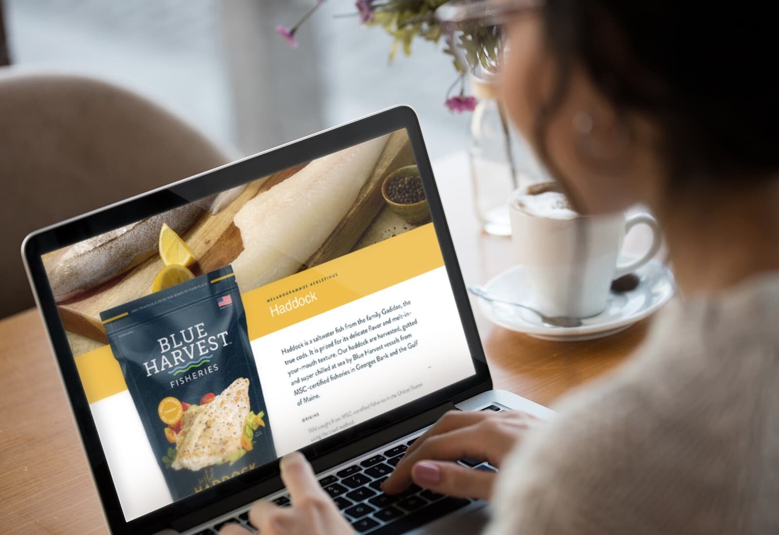 A woman looks at the Blue Harvest Fisheries website on her laptop