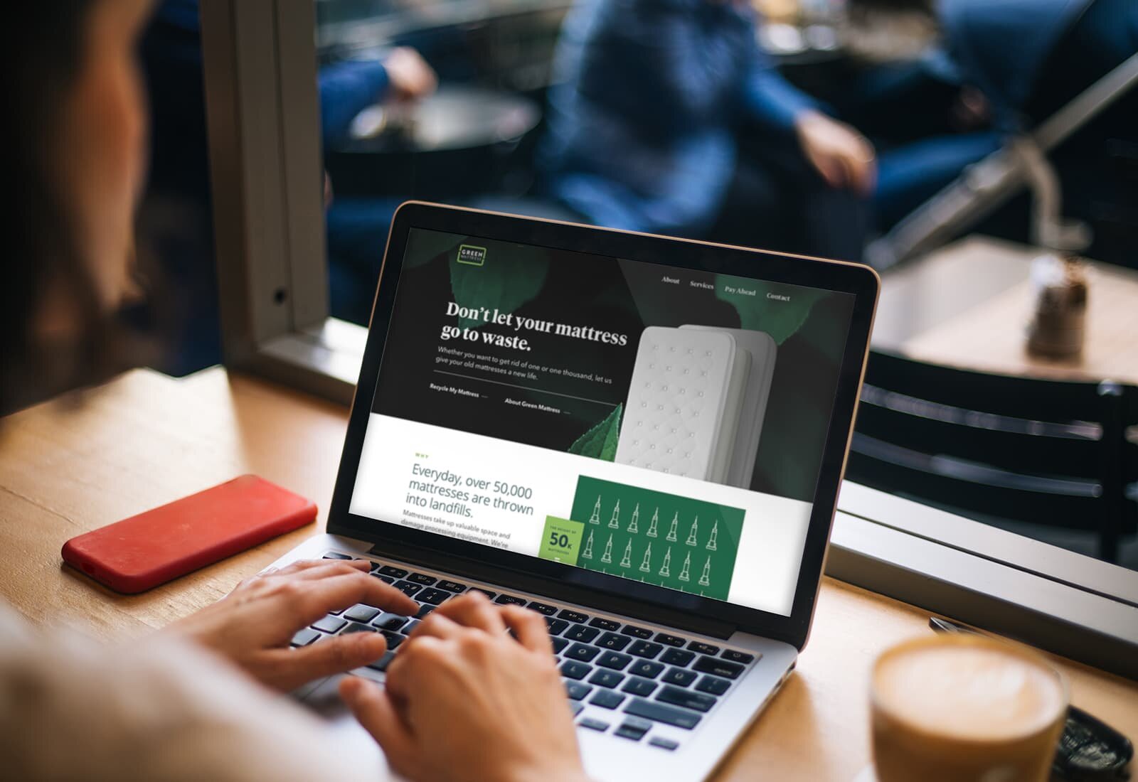 A laptop showing the Green Mattress website