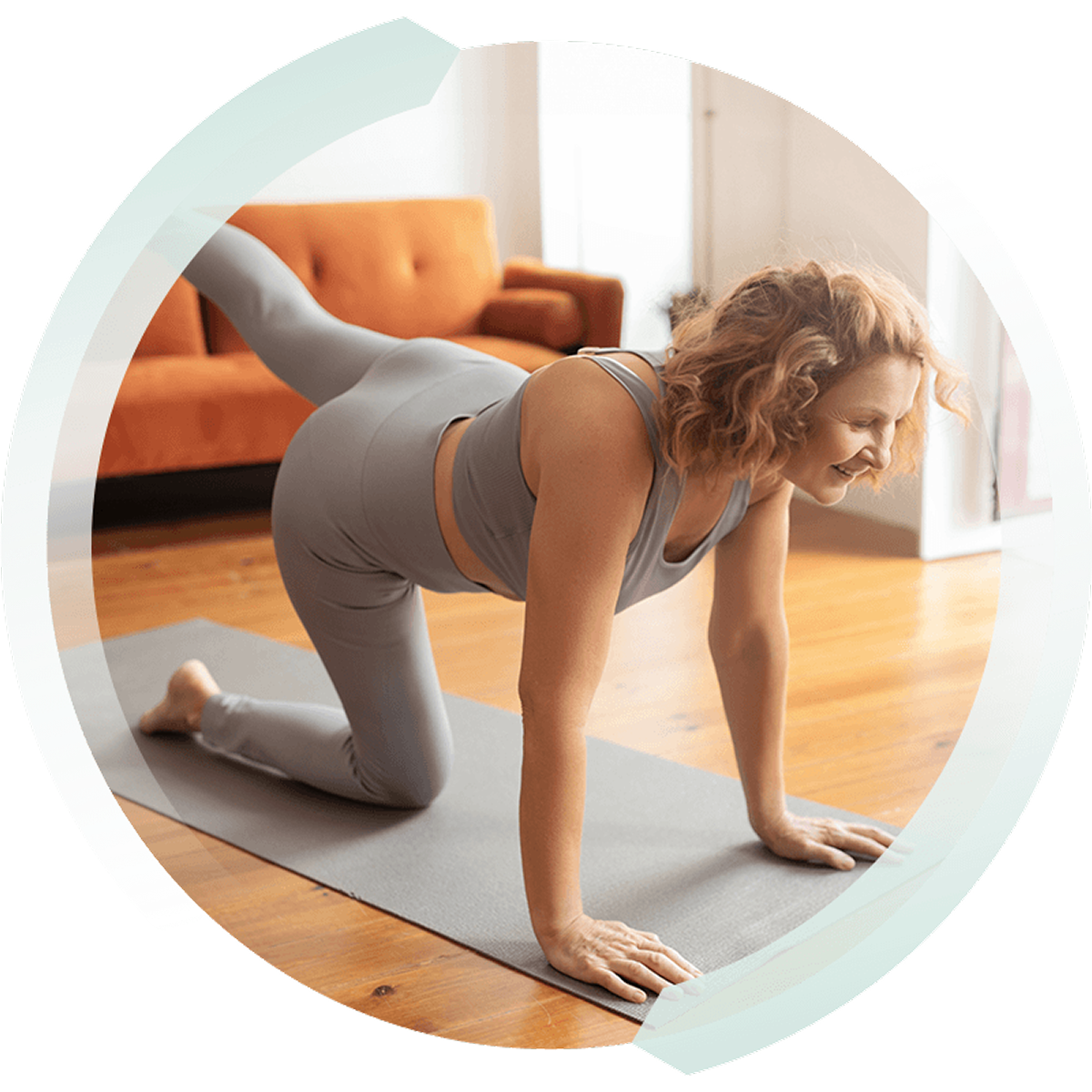 A woman is doing a leg lift on a yoga mat in her living room.
