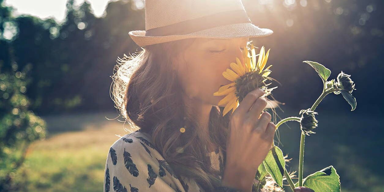 woman smelling a flower