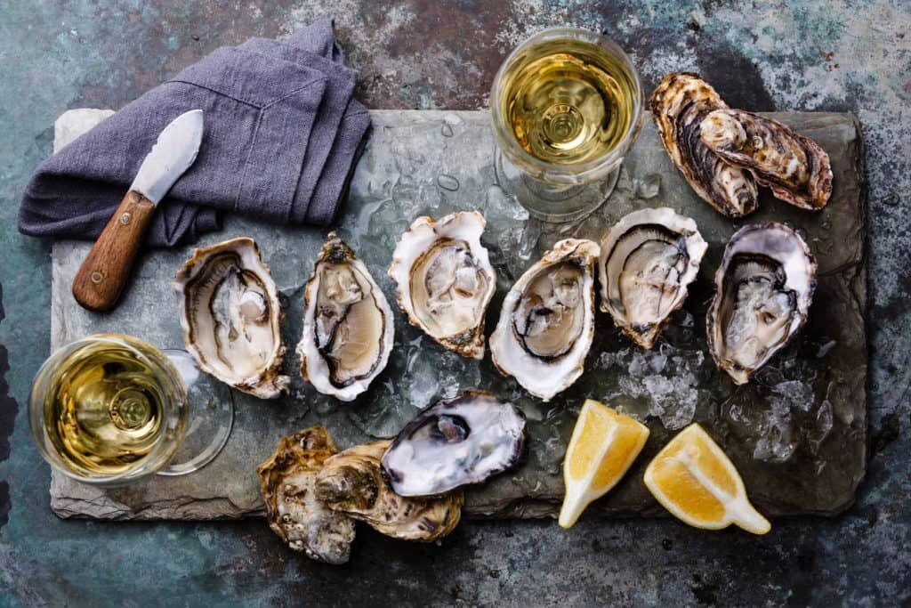 fresh oysters plated with lemon slices