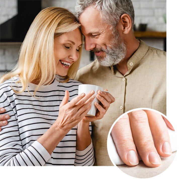An older couple is smiling and embracing while holding a mug, with an inset close-up of healthy nails.