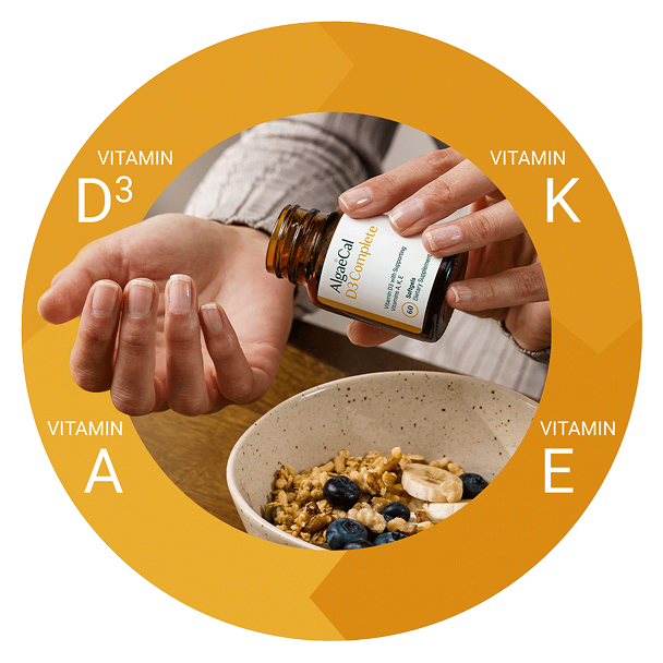  A person's hands are shown pouring an AlgaeCal D3 Complete supplement into a bowl of cereal. The image is framed by a gold circle with the text "Vitamin D3," "Vitamin K," "Vitamin E," and "Vitamin A."