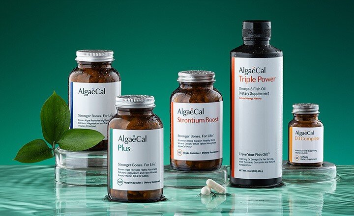 Bottles of AlgaeCal, AlgaeCal Plus, Strontium Boost, Triple Power Fish Oil and D3 sitting on glass with water ripples below.