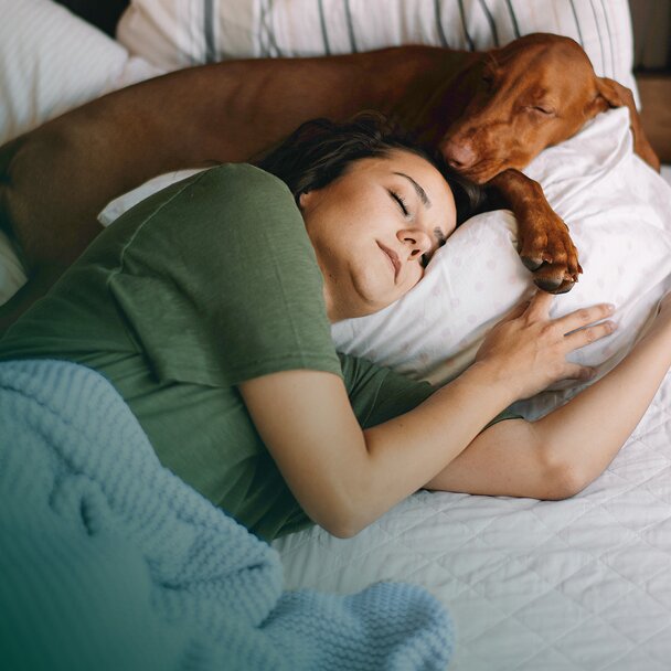 Woman and dog asleep 