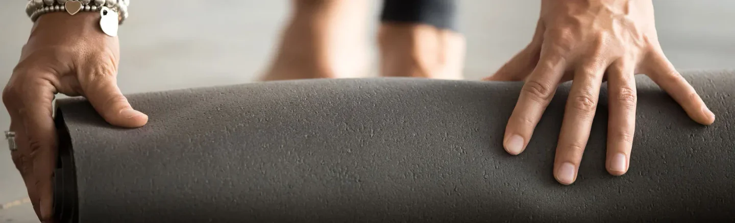 Someone rolling an exercise mat