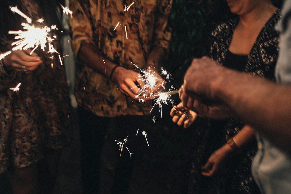 group of people lighting sparklers