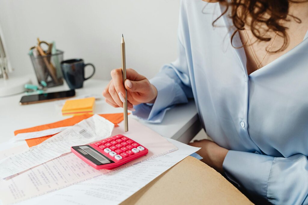 woman budgeting with calculator and receipts