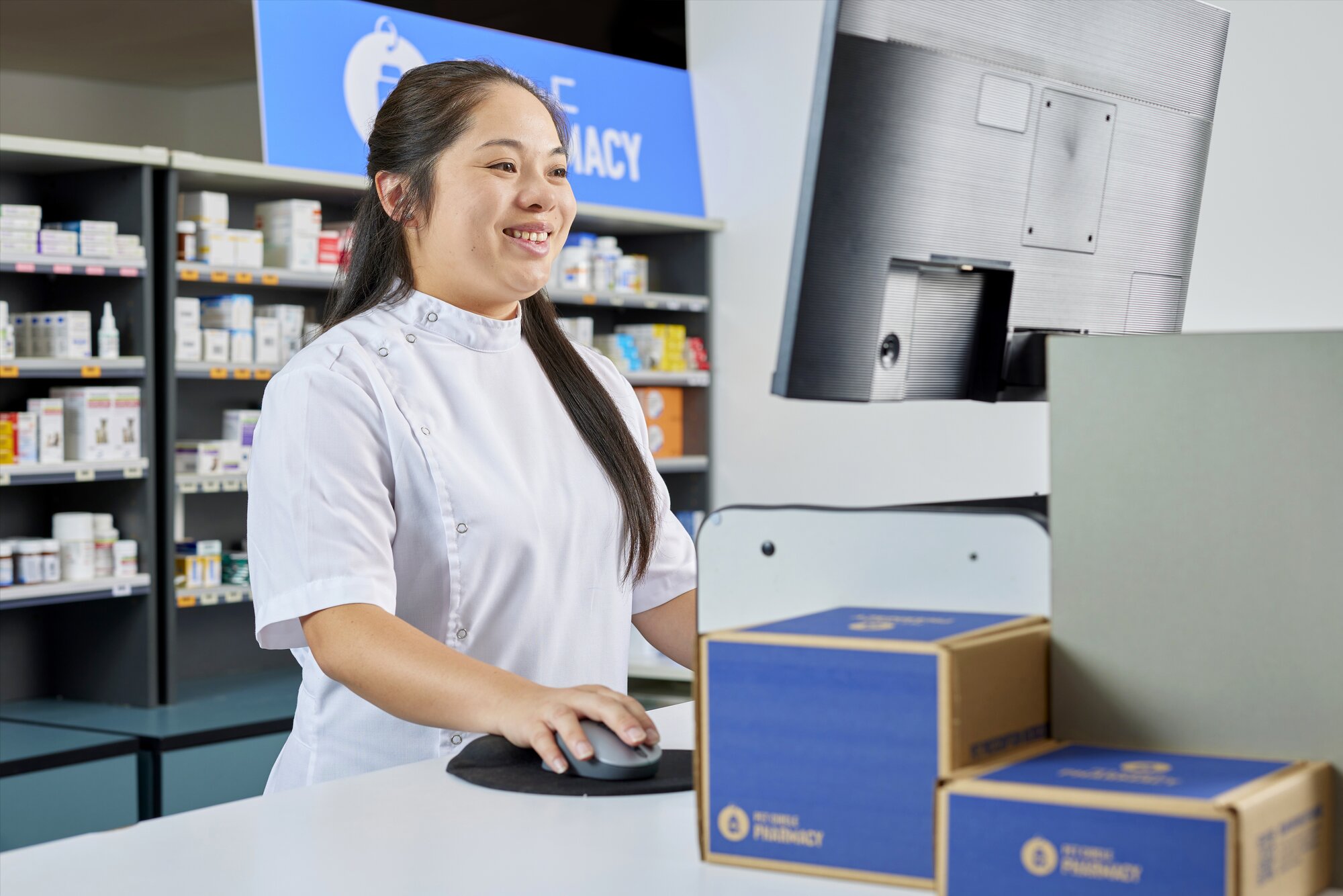 Pet Circle Pharmacist on the computer in the pharmacy