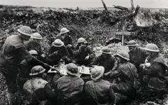 In this undated photo, Allied soldiers eat and drink in a shell hole in France during World War I. AP file photo.