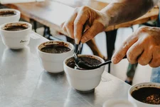 Coffee cupping is a standardized way for evaluating the qualities of coffee. Photo by René Porter on Unsplash.