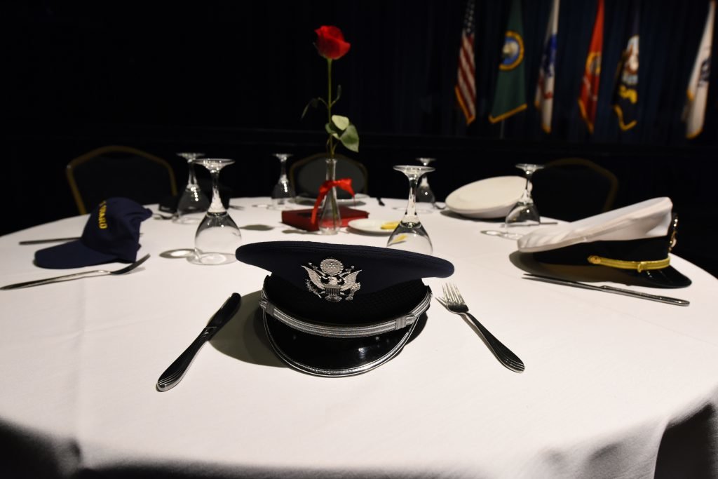 A table in memory of U.S. military prisoners of war and those missing in action stands near the stage at Fairchild's Air Force Ball at Northern Quest Resort and Casino in Airway Heights, Washington, Sept. 15, 2018. The tradition of setting a separate table in honor of POWs and MIA has been in place since the end of the Vietnam War. Photo by Airman 1st Class Lawrence Sena/US Air Force, courtesy of DVIDS.