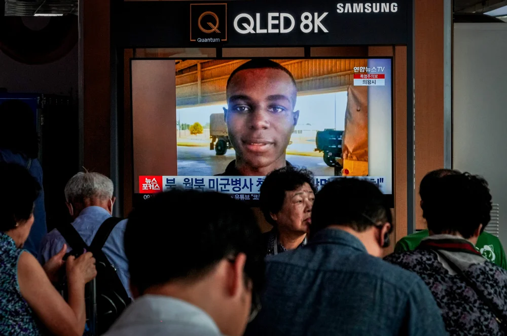 A TV screen shows a file image of American soldier Travis King