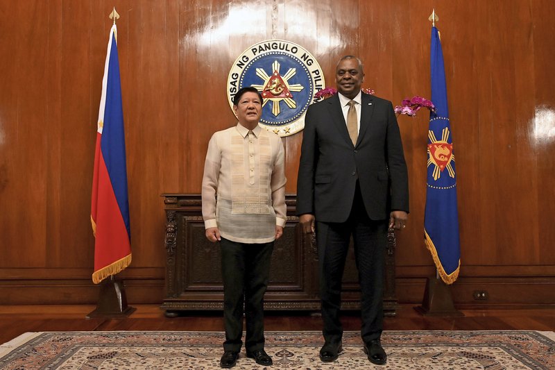 U.S. Secretary of Defense Lloyd James Austin III, right, poses with Philippine President Ferdinand Marcos Jr during a courtesy call at the Malacanang Palace in Manila, Philippines on Thursday, Feb. 2, 2023. (Jam Sta Rosa/Pool Photo via AP)