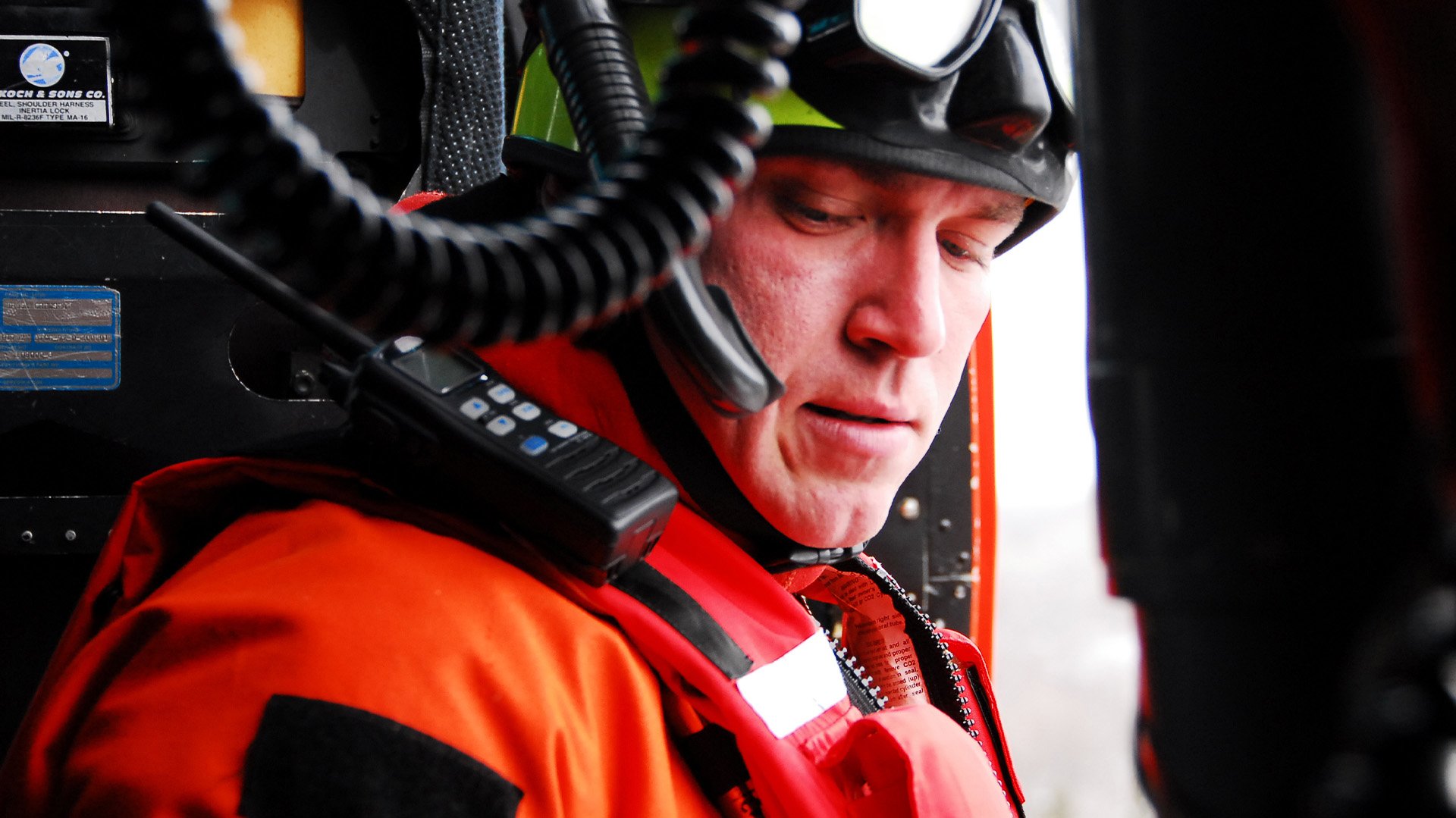 A US Coast Guard rescue swimmer gears up, ready for deployment to an emergency. US Coast Guard photo by Petty Officer 3rd Class Brandon Blackwell.