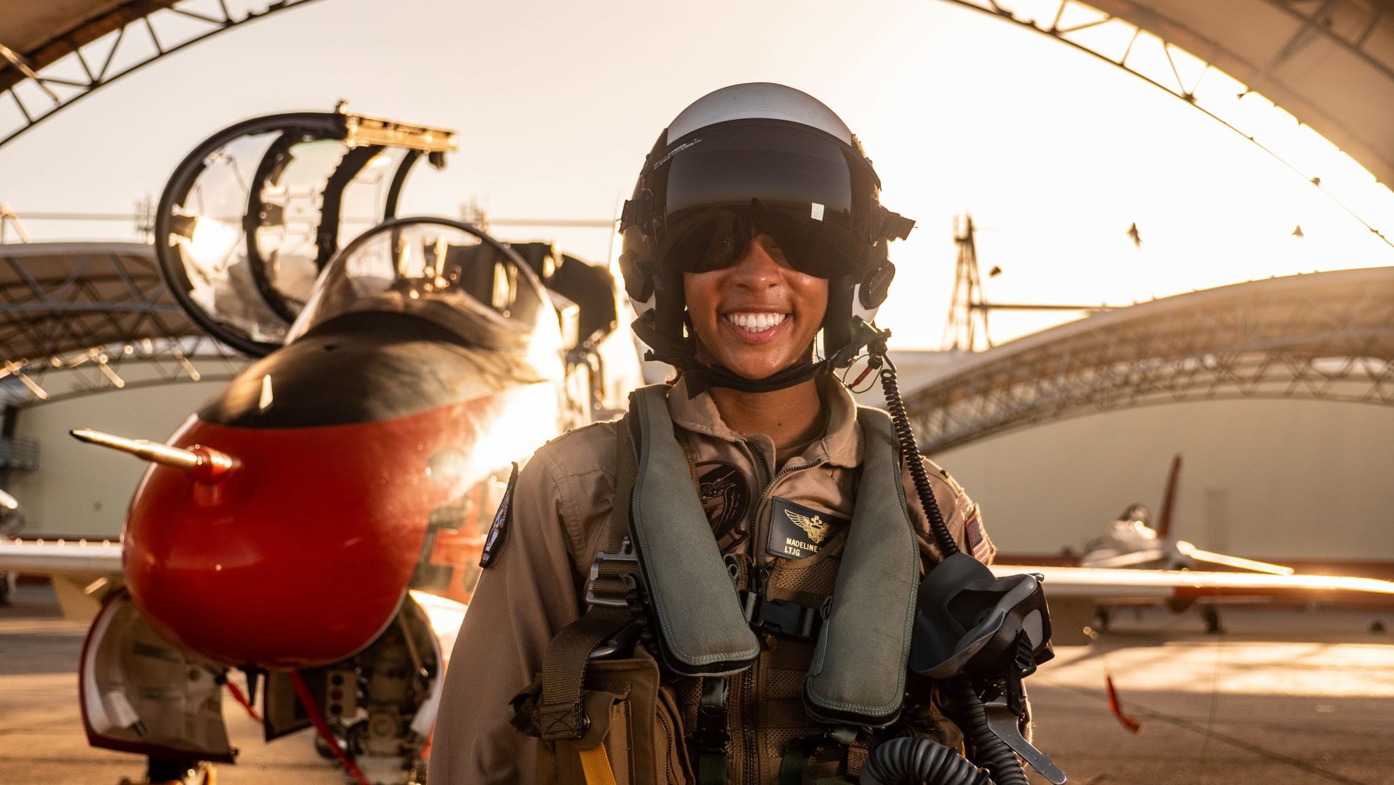 Lt. j.g. Madeline “Maddy” Swegle poses for a photograph in front of a U.S. Navy T-45 Goshawk training aircraft during undergraduate Tactical Air (Strike) pilot training syllabus at Naval Air Station Kingsville, Texas. Swegle is the Navy’s first Black female to graduate and become a tactical jet aviator. (U.S. Navy photo by Austin Rooney/released)