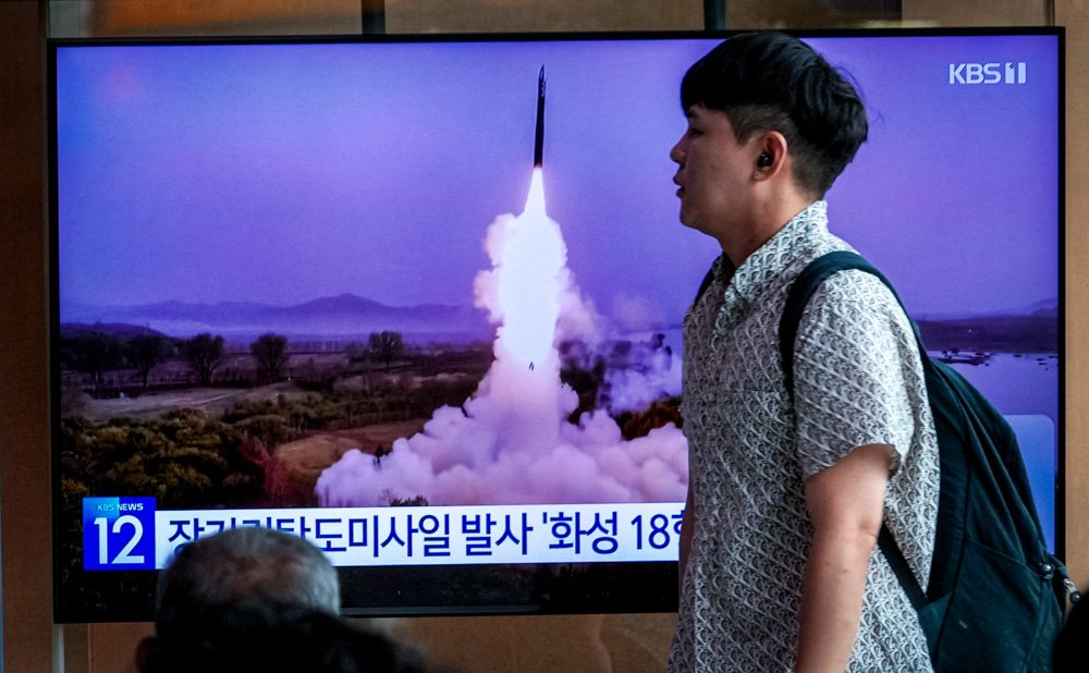 A TV screen shows a file image of North Korea's missile launch during a news program at the Seoul Railway Station.