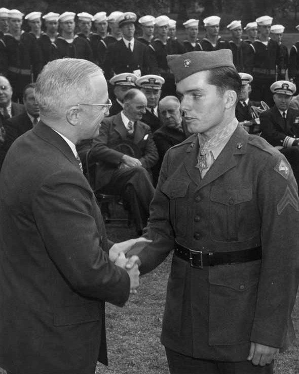 Corporal Douglas T. Jacobson, USMC. Being congratulated by President Harry S. Truman just after he was presented with the Medal of Honor, during Nimitz Day festivities at the White House, Washington, D.C., 5 October 1945. 1945. Photo courtesy of Naval Historical Center