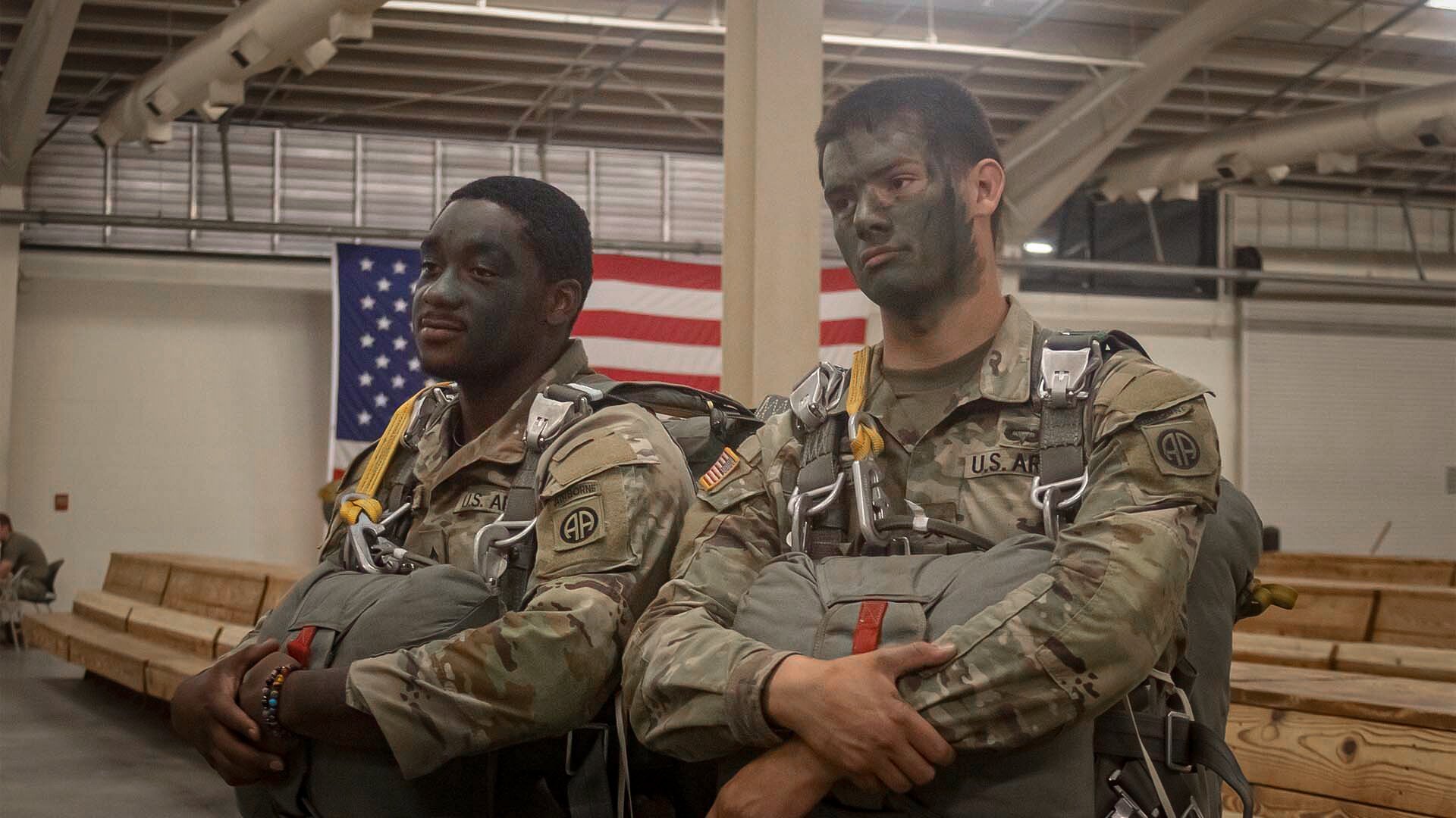 Two paratroopers with the 82nd Airborne Division wait to load onto a C-17 for a mass tactical jump on Sicily Drop Zone at Fort Bragg, North Carolina, Sept. 14, 2022. Photo by Jenna Biter/Coffee or Die Magazine.