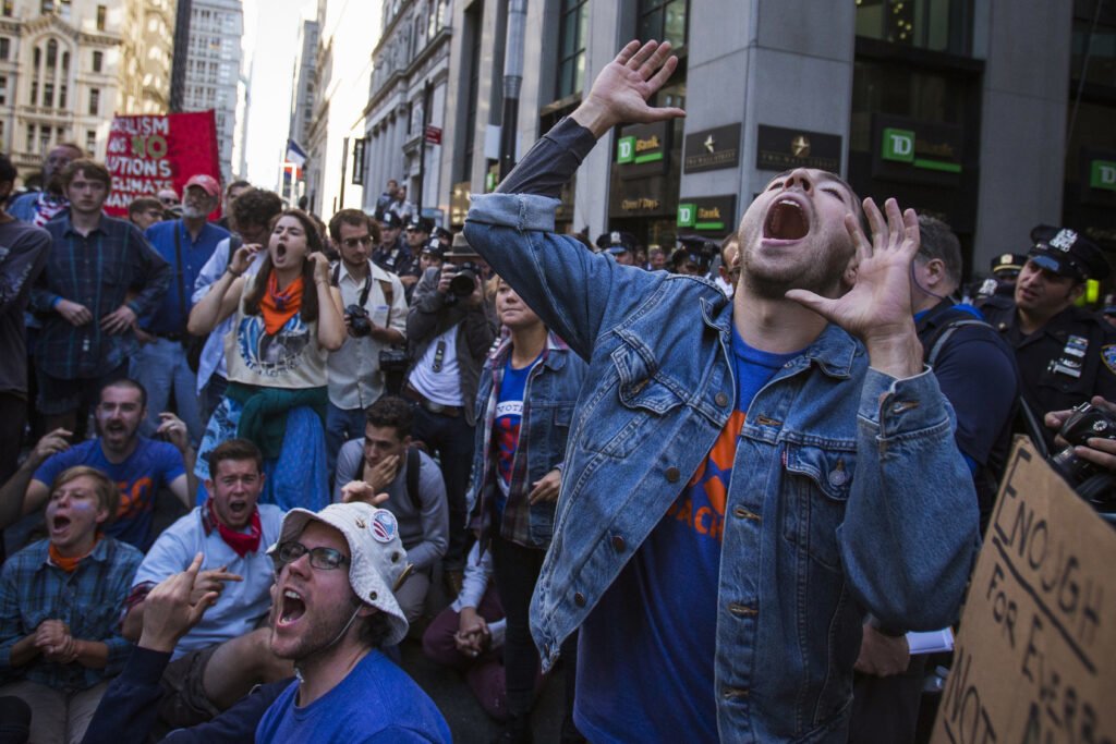 Protestors shout slogans while taking part in the 'Flood Wall Street' demonstration in Lower Manhattan, New York