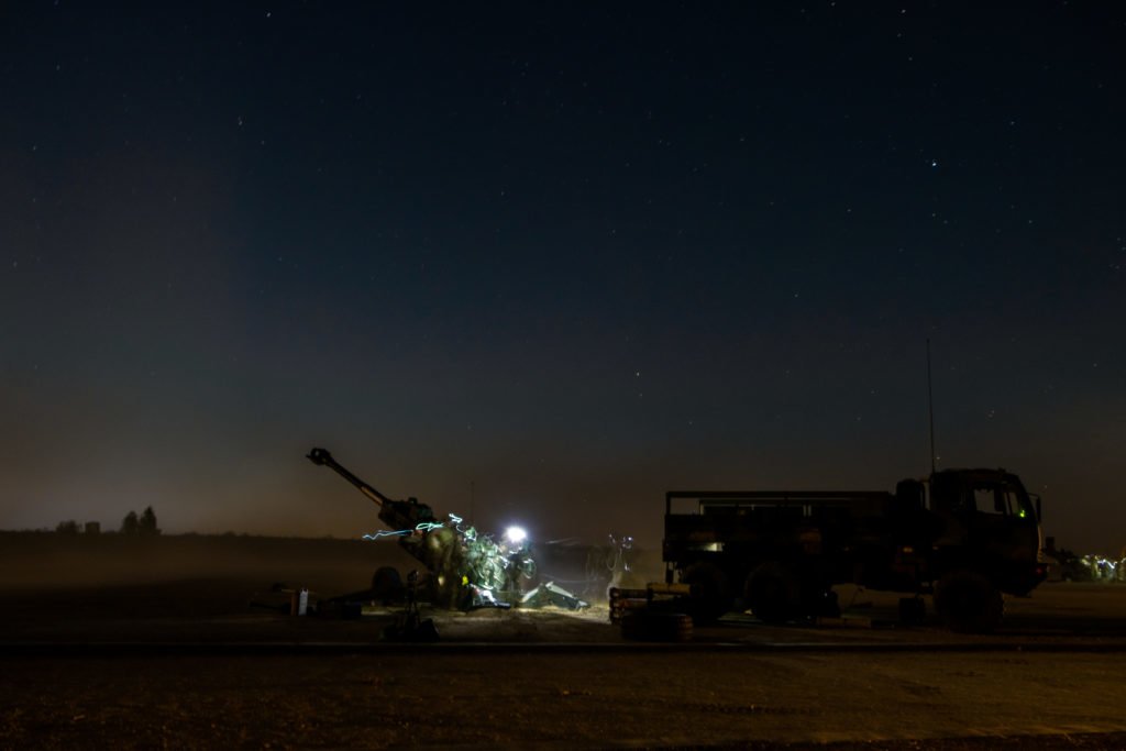 A cloud of dust kicks up after the gun fires its first cacophonous volley of shells.