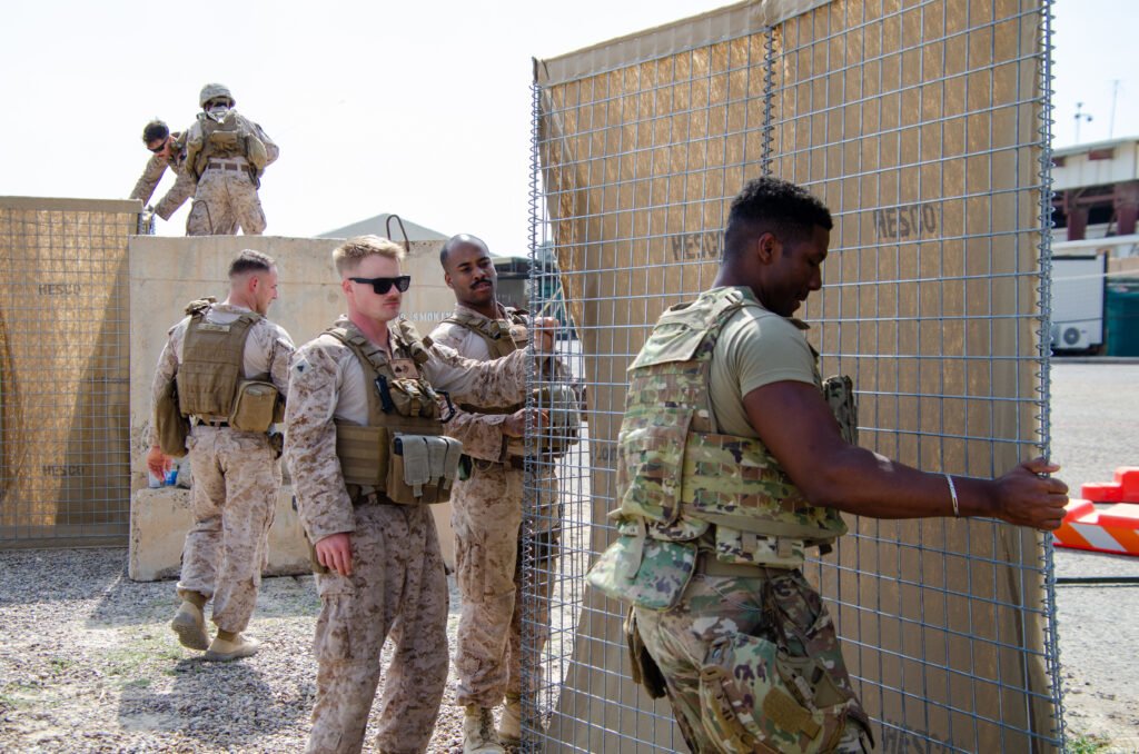 Marines and soldiers at Camp Manion construct Hesco barriers as they build new bunkers after the Taji strikes. Photo by Kevin Knodell/Coffee or Die.