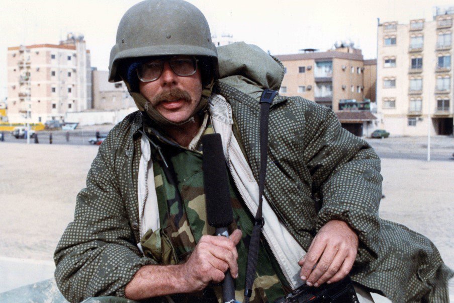 Mike Sullivan, with his recording gear in hand, enters Kuwait City in late January 1991. Photo courtesy of Mike Sullivan.