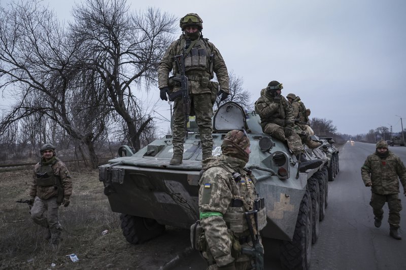 Ukrainian soldiers stand atop on APC before going to the frontline in Donetsk region, Ukraine, Saturday, Jan. 28, 2023. (AP Photo/Andriy Dubchak)