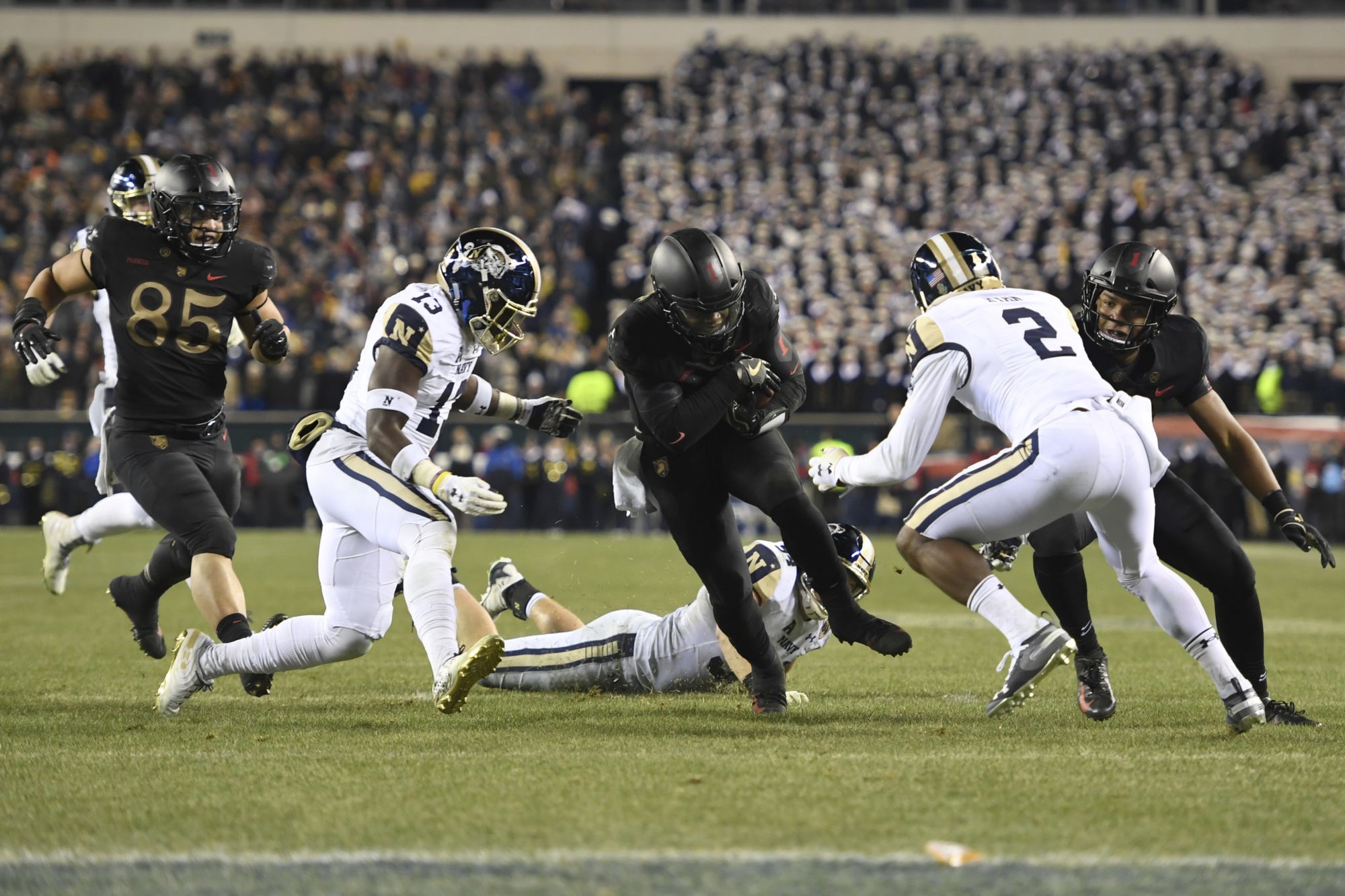 PHILADELPHIA, PENNSYLVANIA – DECEMBER 08: Kelvin Hopkins Jr. #8 of the Army Black Knights drives toward the end zone against Juan Hailey #13 and Jarid Ryan #2 of the Navy Midshipmen during the third quarter of the game at Lincoln Financial Field on December 08, 2018 in Philadelphia, Pennsylvania. (Photo by Sarah Stier/Getty Images)