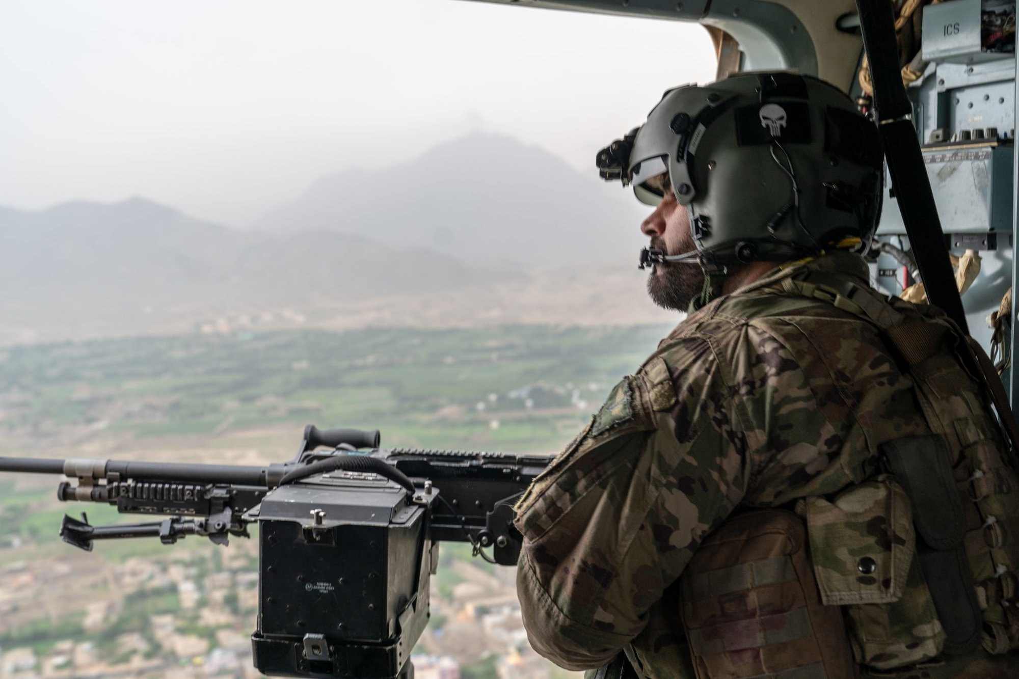 A crew chief for the Afghan Special Mission Wing scans the city of Kabul during a mission in 2018. Photo by Marty Skovlund Jr./Coffee or Die Magazine.
