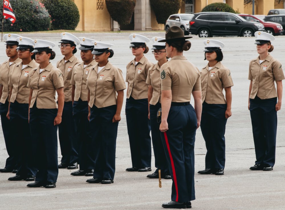 US Marine Corps Staff Sgt. Amber Staroscik, a senior drill instructor with Lima Company, 3rd Recruit Training Battalion, prepares to instruct her Marines in formation during a graduation ceremony at Marine Corps Recruit Depot San Diego on May 6, 2021. Lima Company is the first integrated company at MCRD San Diego to train female recruits. US Marine Corps photo by Sgt. Sarah Ralph, courtesy of DVIDS.