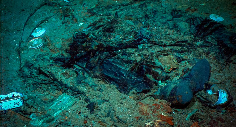 This 2004 photo provided by the Institute for Exploration, Center for Archaeological Oceanography/University of Rhode Island/NOAA Office of Ocean Exploration, shows the remains of a coat and boots in the mud on the sea bed near the Titanic's stern.