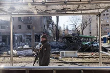 A member of the Ukrainian military stands amid debris from a damaged Kyiv residential apartment block caused after a Russian rocket was shot down by Ukrainian air defenses on Monday, March 14, 2022. Russian forces continue to attempt to encircle the Ukrainian capital, although they have faced stiff resistance and logistical challenges since launching a large-scale invasion of Ukraine last month. Russian troops are advancing from the northwest and northeast of the city. Photo by Chris McGrath/Getty Images.