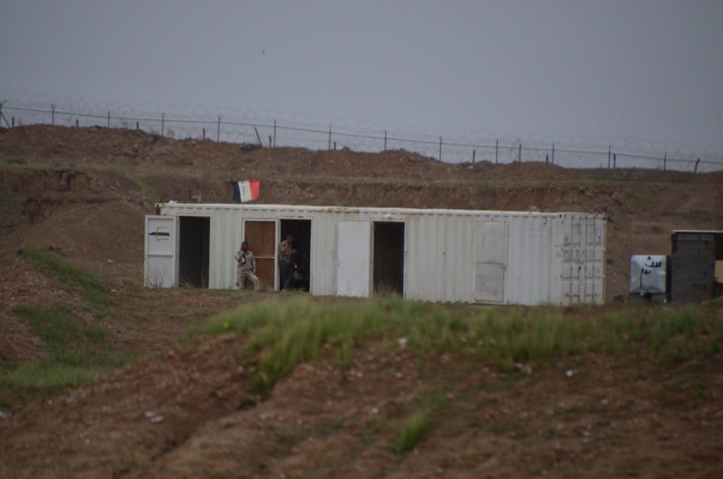 Iraqi troops watch U.S. Marines as they patrol Al Taqaddum Air Base. Photo by Kevin Knodell/Coffee or Die.