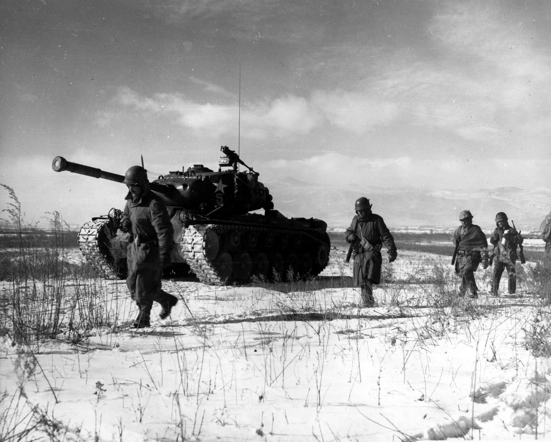 A column of troops and armor of the 1st Marine Division move through communist Chinese lines during their successful breakout from the Chosin Reservoir in North Korea. Wikimedia Commons image.